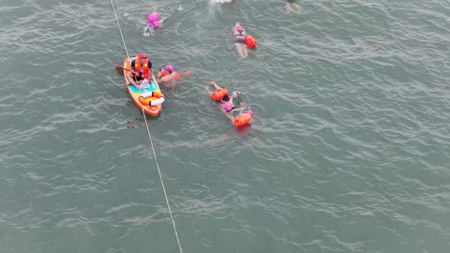 Swimmers Along Rope Lane