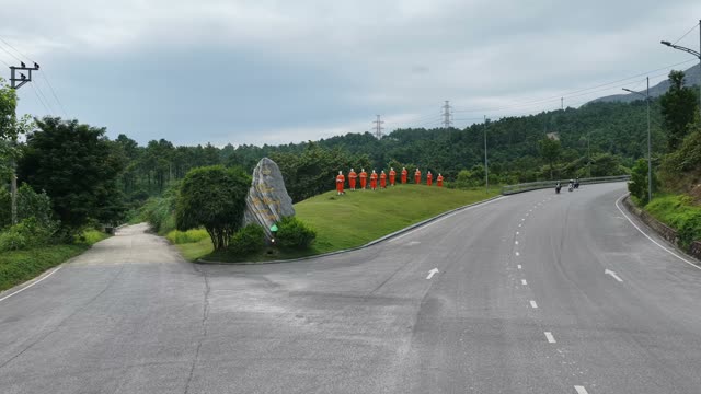 Curving Road Monk Statues