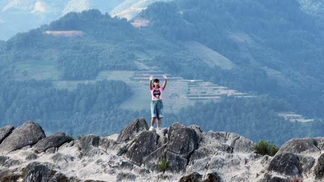Arms Raised On A Mountain Top