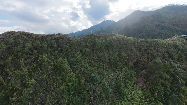 Forested Peak And Drifting Clouds