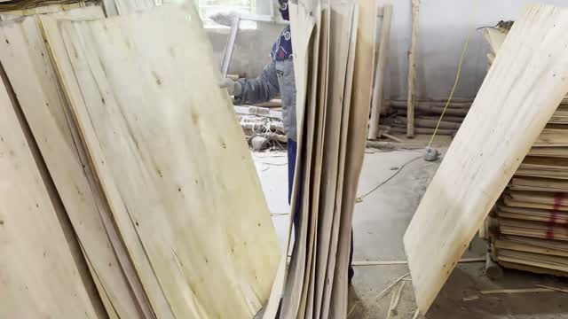 Worker Handling Veneer Panels