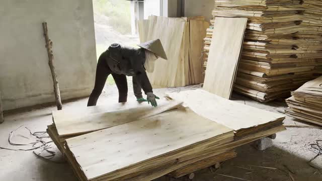 Worker Flattening Veneer Sheets