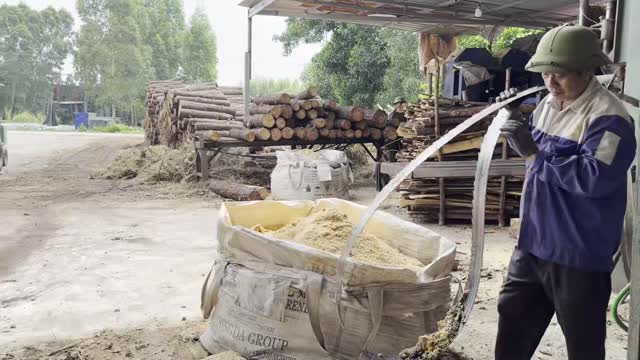 Packing Sawdust Into Sack