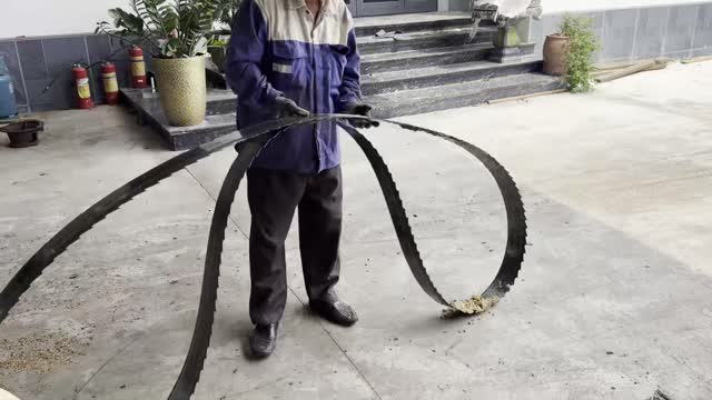 Worker Holding Band Saw Blade