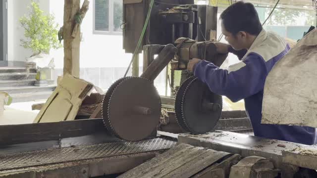 Worker Servicing Circular Saw