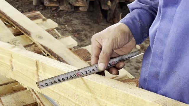 Measuring Wooden Plank By Hand
