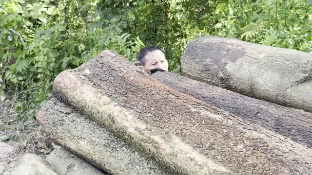 Boy By The Log Pile
