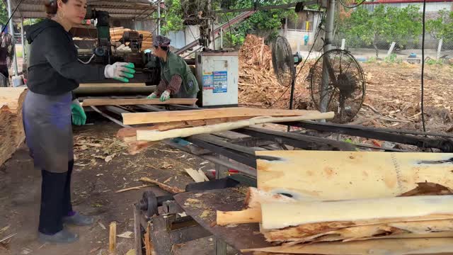 Worker Handling Sawn Boards
