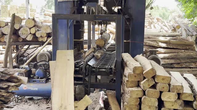 Worker Beside Saw Machine