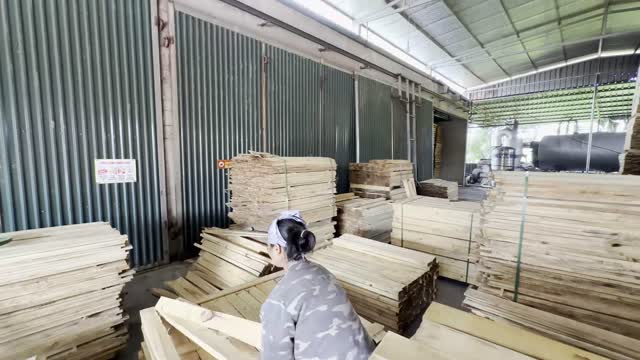 Worker Sorting Timber Boards