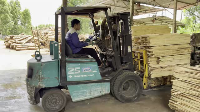 Forklift Lifting Plank Stack