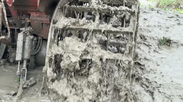 Tiller Mechanism Dripping With Mud