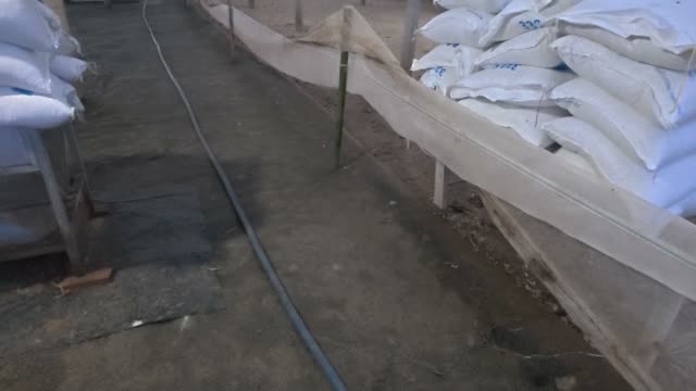Feed Sacks Stacked In Barn
